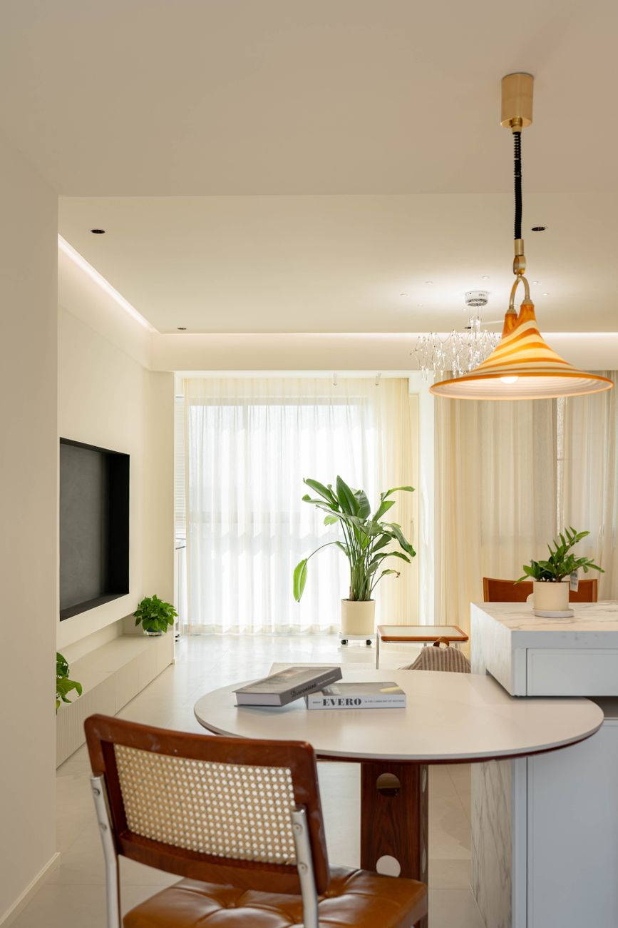 Bright, minimalist living room with plants and stylish lighting.
